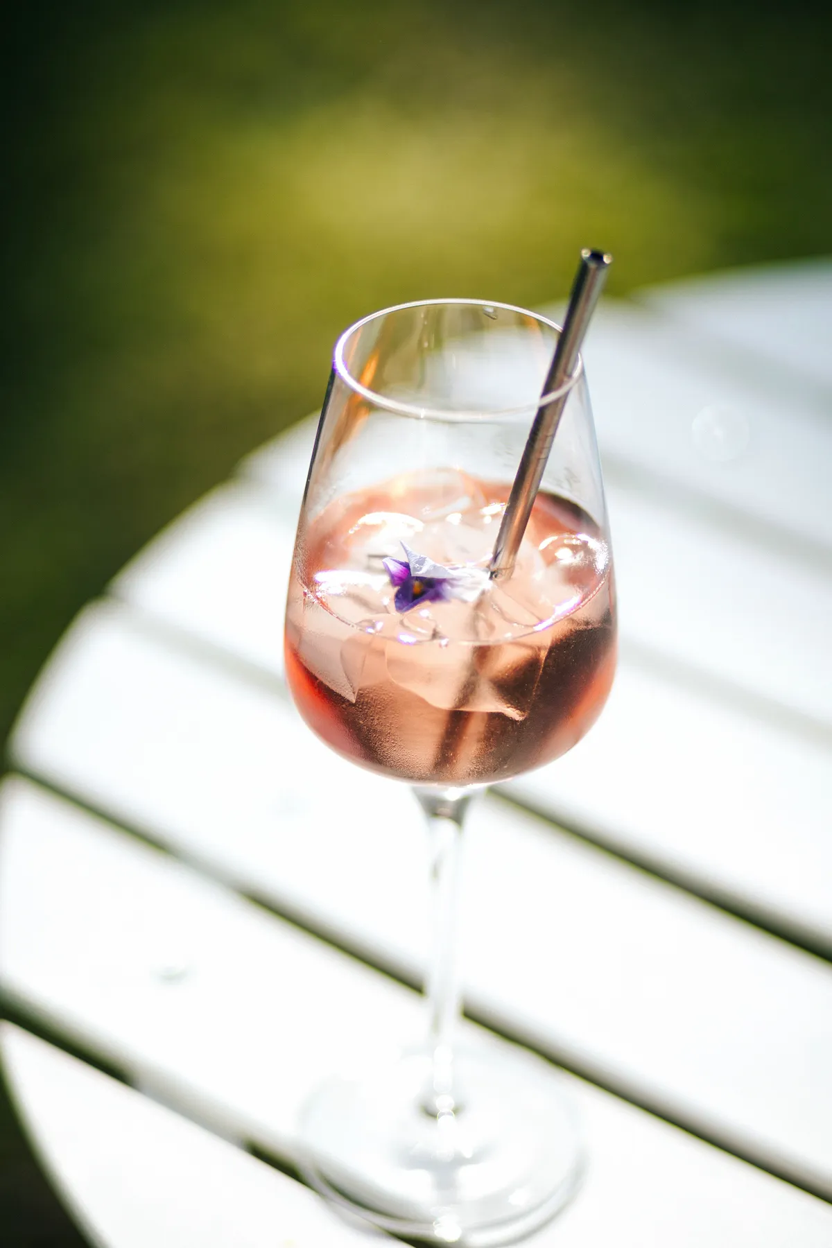 Cocktail raffiné décoré de fleurs, posé sur une table au vin d’honneur d’un mariage au Domaine de Guillon